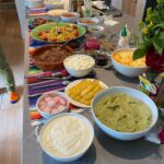 Ulrika Jonsson Instagram – So.
Everyone who knows me well, knows this is my happy place.
Cooking. Hosting. Table-laying. Flower arranging. Making a fuss. Paying attention to detail.
And generally wearing myself out.

Third Ungrateful requested tacos for her 18th.
And she got more than she bargained for.

Beef fillet tacos.
Pork Carnitas.
Courgette, corn, shallot, mint, feta tacos.
Guacemole.
Too much cheese. 
Pink pickled onions.
Refried beans.
Sriracha mayo.
Chargrilled corn. And pineapple (just cos).
All the trimmings.
A lot of rum and limes.
And Frida Kahlo came, too.

Hostess with the mostest.
And yes, ALL Mexican people have moustaches and wear sombreros. Fact.