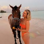 Victoria Spence Instagram – The most special morning 🥹🫶🏻

Every morning the race horses are taken to the beach at sunrise to roll in the sand, have a swim and get bathed. 🌅

We got talking to one of the guys and he asked if I wanted to get in, and next minute his hands were out ready to push me onto the horse😅 my heart was in my mouth at first, but it was the most precious experience! I’ll literally never forget it🥹

To top it off, he told me the horse was called Jerusalema after the song, which if you’ve been here a while, you’ll know my obsession with that song- one of my faves ever!🥲

I’ll remember this morning forever ❤️ 
@mikesingym can we get a horse?!
#barbados#corememory