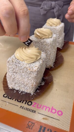 Adriano Zumbo Instagram - A little sweetness 🤎
Our new Salted Caramel Lamington 👀
#zumbo #zumbotest #lamington #love #cake #sweetness #noosa #noosaville #heaven #sunshinecoast
