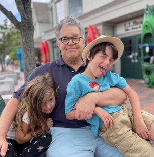 Al Franken Instagram - Spent the week in Maine visiting Franni’s family. Her mom is 99! Here’s me with grandkids Avery and Joe. Flying with them to LA to host Kimmel on Tuesday. I’m hosting not them.