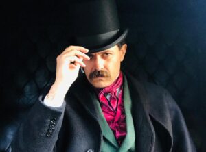 Albano Jerónimo Instagram - THE WORST MAN IN LONDON
directed by Rodrigo Areias | Review 

“Howell is at the centre of this movie as a middle man, a presumed pawn that connects different parts of the game’s “board”: artists and collectors. We follow all of the deals, talks, twists and turns that unfurl throughout the film. With both clear and unclear intentions of personal gain emerging – for Howell and others – the title everything starts off with is then appended with a question mark: was this actually the worst man?

Here, Howell is presented as a multi-faceted prism. In one of the first scenes, Dante whispers in confidence to his wife, Lizzie Sidall: “What a bunch of vampires.” It’s a statement that, in fact, shrewdly describes all of the dynamics at play. The director certainly doesn’t attempt to absolve Howell of his real-life malicious actions (some of which are presented in the film), and he’s shown as a bad man playing a wicked game, but he’s also someone embodying his surroundings. He reflects the art world of the time in a nutshell, perhaps: the bad, sometimes the good, always the talk and sometimes the art. The great performance by Albano Jerónimo, combined with some on-point costume design for the character (with the right mix of discreet and outlandish elements), creates some compelling ingredients that naturally draw our attention to the protagonist.”

by Teresa Vieira

@subtitle_talent @fernandaribasmanagement @leopardofilmes @alfama_films @apm_actionsperminute @iffr