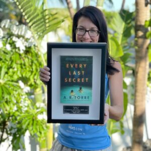 Alessandra Torre Instagram - My publisher surprised me with this beautiful framed copy of Every Last Secret in commemoration of it hitting 100k sales! I’m so grateful to Thomas & Mercer, my readers, and my family for supporting and loving this twisted tale of domestic suspense. 🔪 
Thank you all!