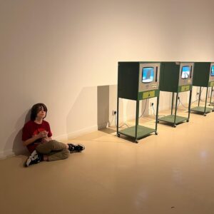 Alexandra Munroe Instagram - My God son George taking a break in the biennial beside Ahmed Mater’s work chronicling the political history of Saudi oil…and other images from the biennial and studio visits…

#diriyahbiennale2021 #riyadh #reforms @sasha.kalter #sarabinsafwan @guggabudhabi #guggenheim