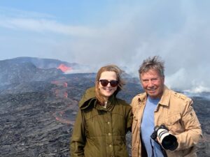 Alexandra Munroe Instagram - In Iceland, Robert and I are celebrating our wedding anniversary. Here we are at the volcano, 500m from the erupting molten lava fires of the caldera. The cold air is singed with molten heat, and the river of lava flows beneath us, at bullet train speed.  A geologist tells us we are looking into the future, 400 to 500 years, when the geothermal vestiges of this eruption today will warm the planet then. The rugged landscape, giant waterfalls, cracked mountains, vast lava fields and of course, the endless light have captured our imagination. It’s a magical place. 

#iceland #volcano #anniversary #lava #bluelagoon #dalur @robertrosenkranz