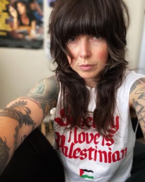 Alexis Krauss Instagram - what does protest look like for me now as a sleep deprived and over scheduled mother of a 7 month old?

for now it’s sitting in my little cousin’s bedroom while my baby naps taking selfies in this t-shirt designed by @sabri. shirt sales support mutual aid for Gaza

it’s no radical act but for now it’s what i can do. i struggle everyday thinking about how to express my outrage over what continues to happen in our world. i truly believe that even the smallest acts matter. keep feeling, keep having conversations with loved ones. keep mothering and keep loving with all your might. keep protesting even if your capacity is limited. it all matters.