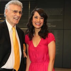 Ali Ewoldt Instagram - Yesterday we said goodbye to my mentor and teacher, conductor and director and coach, the man who made us all promise to give him “all the credit and ten percent” and truly deserved it, Dr. Renato Vellutino, aka “Doc.” Doc took me on as a voice student at age 10 and gave me a foundation of technique I still rely upon. He made musical theater in our small public high school, Pleasantville H.S., important and exciting and something for the entire community to participate in. He taught us that “fun is excellence and excellence is work” and that every single person onstage and off was valuable and critical in putting on a show. He came to see me on tour and on Broadway and at 90 years old, remembered every solo I sang with our high school chorus. He loved his family and his students passionately and made sure that we knew it. I can never thank you enough, Doc, but I promise to carry your legacy forward always.

1. Doc coming to see me play Tuptim in The King and I at LCT (a role he cast/directed me in in H.S.)
2. Doc directing us in Kiss Me Kate
3. Doc, his son Gian-Carlo, grandson Jake and I recreating a scene from KMK in an “Encore” parody I never finished in 2020
4. Singing for Doc and Mrs. V from a safe distance in 2020
5. Doc’s 90th Birthday
6. Part of the Les Miserables medley we did in HS (on VHS)
7. To live in hearts we leave behind is not to die