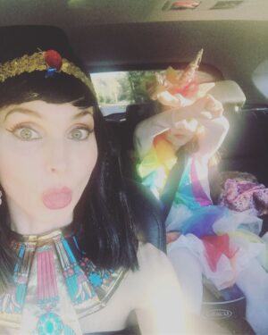 Alicia Minshew Instagram - Bring on Halloween! Donning my Cleopatra attire as we drive to my sister's party yesterday. It was a bright and gorgeous fall day. Miss Priss is very focused on her lipstick while her sneaky momma tries to catch her in action. Trying to perfect her rainbow unicorn. She sees me and is not having it! 😝Swipe to see how she turned out. So sweet. She did it all herself! Richie's costume is a whole other post! 🤣 #earlyhalloween #falltime #rainbowunicorn #mygirl #lipstick #misspriss #cleopatra #welovedressingup #happyfall