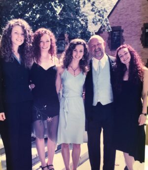 Alicia Minshew Instagram - Ahh to celebrate #nationalsiblingday I thought I would post a photo of a priest,a lawyer and 3 hussies! Guess which is which! 😬 For real. This was my Daddy’s wedding day with my 3 amazing sisters! My sisters are the most fun, beautiful, hilarious curly haired chicks I know! Now that is a lot of hair! We stole it from my Dad’s head. 😁 Good job Father Jim! (We all know there is at least one hussy in blue!)🙋🏻‍♀️ #preachersdaughters #happynationalsiblingday #sisters #love #thebest #curlygirls