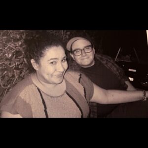 Amanda-Faye Jimenez Instagram - At a party recently, someone asked Jo if they come to all of my performances. They said yes, and described themselves as my “Dance Mom” which is very funny, but also I would not have guessed that they knew about the show Dance Moms if you had asked me.

Jo, two things among many I love about you are that you often surprise me even when the answer is unsurprising, and you let me be the funny one in public most of the time, except when it comes time to roast me, when you really just cut loose. 

Not to be obnoxious, but also recently, we were at a diner and the young gay server said we were so cute because we were holding hands across the table. I wondered if he thought we were a new couple. It suddenly felt important to me that he know we aren’t, and that such things are possible over a decade down the line, because I didn’t know that before, and I wish I had. I am so grateful I do now.

Jo, two more things I love about you are that you hold my hand a lot, and whenever I’m walking very closely behind you, my boob crashing into your back un-erotically as you are trying to navigate us to our destination, you say “why are you walking so close to me?” even though, or I guess I kinda hope because, you know I will say “I like to be very close to you! I wish I could just walk inside your skin!” And then you call me a creep, and we laugh. 

My love, thank you for holding me up somehow more than ever this past year, when I was so scared to step on stage I wanted to run, when I was literally falling over with grief. Sorry to say, but you kind of HAVE been letting me walk inside you, or maybe the other way around, but in any event, I couldn’t have stood at all without your strength, of course, but most of all the playfulness of our love. You add meaning to every moment of the day for me. Happy Valentine’s Day, I love you so! 💕💫