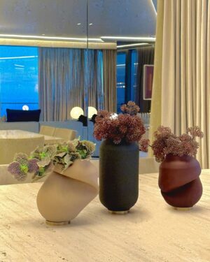 Andrés Mercado Instagram - Dinning in heaven starts with uninterrupted ocean views and off course this chic art piece from the most important Colombian artist of all times, Fernando Botero. Along this perfection we customized an oversized  marble table in travertine and add some softness with the velvet chairs, we can not missed the flower arrangements by @lafloreria.atelier on top of the Vanitas Set Rubber Vase by studio b severin Germany, under the light of this majestic 1960s flush mount thanks to @1stdibs .