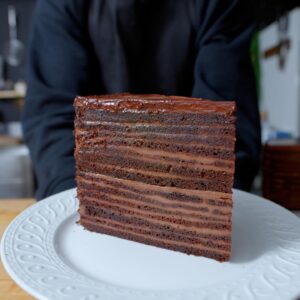 Andrew Rea Instagram - Inspired by Strip House’s famous 24 layer cake, @alvin.zhou made a stunning 28 layer chocolate cake. See it all come together at the link in bio!