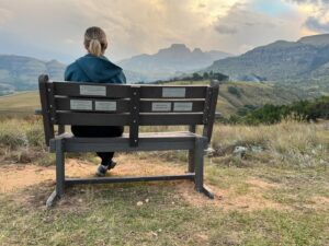 Anel Alexander Instagram - “In Loving Memory of ’The Prince of Gingers’, James Alexander, 8 Jan 1978 - 28 Apr 2023. By His Grace. For James, who loved this view, from Anel, who always sat beside him.”

On Sunday 28 April 2024 a bunch of family and friends went to the Drakensberg to scatter James’ ashes and put up a memorial bench for him. It felt surreal. One regularly sees those benches in parks and overlooking beautiful vistas. But it always belongs to somebody else. Some other ‘Beloved Grandpa’ or ‘Mother, daughter and friend, RIP’. But this time it was my bench...

My family has a home in the Central Drakensberg and James and I’ve been going there for the 22 years we were together. From our honeymoon in April 2003 to our very last ‘holiday’ 2 weeks before his terminal diagnosis end of January 2023.

We put up a bench for him in our favourite spot and planted a tree with his ashes. We had a really special memorial weekend with the friends and family. We laughed and cried, shared memories and photos and thanked God for his life. We decided to put a few different plaques on his bench as it was impossible to just sum him up in a few words. James would have liked it.

It was a beautiful, heartbreaking weekend and I was just reminded again about how we cannot do this alone. We need our family and friends. And also, we need to realize, that someday, it’s gonna be your bench. That’s just part of life. Try to live a life that will elicit people to write the kind of messages that James, despite all his tortured flaws, deserved on his bench. Our bench…