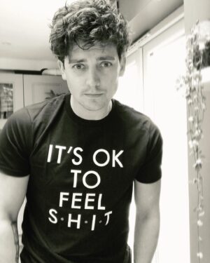 Aneurin Barnard Instagram - As its #mentalhealthawarenessweek I wanted to show my support to @sohappyintown & her team. Including @youngmindsuk by wearing this t-shirt. All money goes to helping struggling minds in need of our help.
I feel extreme pressures with mental health. I struggled with this as a teenager & even now as an adult whilst working or not working in my industry. Especially when the work simply dries up!!! #itsoktofeelshit is more than just a hashtag. Don’t feel alone in the darkness. There is always a light to help you. ITS OK TO FEEL S.H.I.T. Please support @youngmindsuk  and @sohappyintown