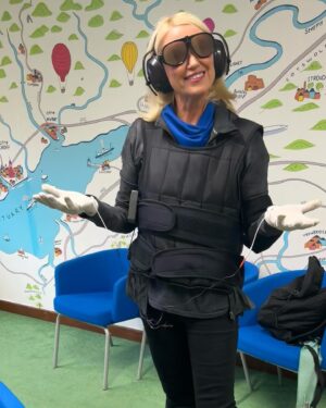 Anneka Rice Instagram - I’m on The One Show tonight at 7pm talking about this suit. No, I’m not on a land mines mission! This is an Empathy Suit. The idea is it gives the care-giver an insight into the struggles of someone with dementia. I was a bit sceptical - thought it might be a gimmick - as empathy is an innate thing, not something you learn. But the suit - weights on the feet and body, goggles to emulate cataracts, ear phones to demonstrate tinnitus, gloves to emulate  Parkinson’s - certainly would give someone a better understanding of what it’s like to feel out of control of your body, after decades being a brain surgeon, Headmistress, top lawyer. It was lovely to meet the team at Deerhurst Care Home in Bristol who are doing all they can to give their residents dignity and love. 7pm #bbc