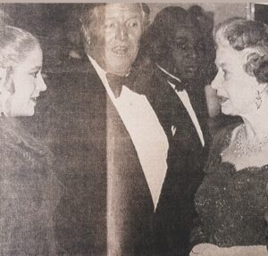Beatie Edney Instagram - @maynard_eziashi put this up of us and Denis Quilley meeting the Queen! All I can remember is being dumbstruck,  because her bra strap was showing. I thought - “All those ladies-in-waiting and no-one has told her to adjust it”. @pauledmonds217 did my hair. #meetingthequeen #royalpremiere #actorslife