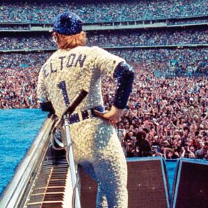 Bob Mackie Instagram - Bob Mackie recreated his iconic baseball cap design for @eltonjohn’s last dates in the US at the Dodger Stadium. 

Bob designed the original costume for Sir Elton’s concert at the stadium in 1975, and it went on to become one of Elton’s most memorable shows. Read the full article in @voguemagazine 

📷 : Ben Bentley / Rocket Entertainment
.
 #MackieMagic #EltonJohn #EltonFarewellTour #EltonLive