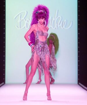 Bob Mackie Instagram - Going into 2023 with this energy 💫 A model walks down the runway at the Fall 2002 Bob Mackie show in New York. #MackieMagic
