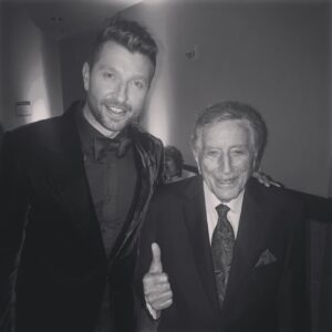Brett Eldredge Instagram - Tony Bennett was such a gift of a human and crooner to this world…not long ago on a beautiful night in Manhattan, he and I were both taping the Rockefeller tree lighting  and our dressing rooms were right next to each other.  As I walked by to go to my room, there he was, eating a granola bar and smiling.  He kindly invited me in and we chatted for a brief and beautiful moment.  I will never forget what that glimmer in time meant to me and my soul.  He was literally 60 years older than me and had seen and accomplished just about as much as any performer could ever dream of and yet, there he was, a fellow singer, waiting for his chance to take the stage once again, just like everyone else, because that was his heart, and damn was he good at it. I have learned so much about singing from his records and his music will live on forever. Thanks for showing us how to live “The Good Life” Tony
