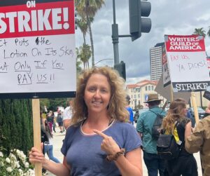 Brooke Smith Instagram - @wgawest picket line today at WB… saw this guy with the lotion sign & had to get a shot with it! #tedlasso showed up to  support, so did @_kismetcollective_ - they let protesters use their bathroom, gave out free water & coffee, and the guy on the motorcycle kept spirits up! @sagaftra