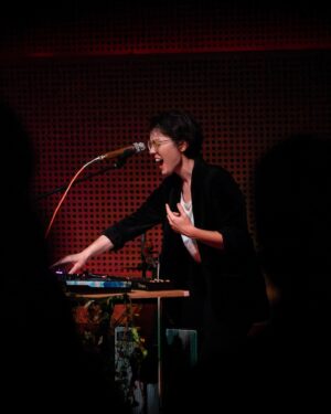 Caroline Shaw Instagram - Thank you so much to everyone who came out to @publicrecordsnyc on Wednesday. We are overwhelmed with gratitude ❤️🥹🐬🌈🪩 if you snagged some merch, please tag us when you wear it! 

📷Thanks @davidandrako for snapping pics 1-5
😳Pic 6 is just an upsetting discovery about how @carolineadelaideshaw is apparently double-jointed and I don’t care if this makes her a better strings player…I can’t unsee it.
⚡️pic 7 is redeeming Caroline’s weird fingers because she looks like a badass (she is, duh) pic by Mr. @jillstrominger (aka @trevor.pour )
👴🏻pic 8 is because then I realized it was also giving frozen dad energy and I won’t stop making this joke. #iykyk