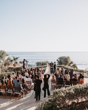 Cassie DiLaura Instagram - wedding details • part three • the ceremony 

• the kiss 😘 I laugh now at how much thought went into this moment beforehand… is everyone out of the way? do I go on the outside of your nose? where’s my arm/hand go? 😂 best part was my brother shouting “alright, that’s enough.”
• last minute decision to add rose petals to line the aisles 👌🏼 @blushnroses.cabo 
• I almost didn’t even make it to the ceremony (story for the next post 😅) but I must have taken 25 deep breaths during this “walk” and somehow managed to not get that veil snatched off the top of my head 😂  I met both my mom and dad at the bottom of the stairs too 🥰 
• 🥲 @brettlazar 🥲
•66 of our favorite people ♥️♥️♥️   @photobyjulieta & @danieljireh working their magic ✨✨
•shoutout to our free officiant!!!! thank you dad #2!!!! ♥️
•shoutout to our 2-year-old ring bearer @therealleebow 😂
•thank you @gerardodiazviolinis for the beautiful, beautiful, beautiful violin music. all of me wanted to cry but I couldn’t ruin my makeup LOL 🎻 
•2/3 of my flower girls 💐 thank you @azazieofficial for the most gorgeous dresses!!! the girls whirled and twirled all night in them 🤍
•the best photo of the wedding… dad catchin’ some 💤 because weddings are exhausting 😂

#wedding #thecape #weddingdetails #florals #weddingvenue #weddingflowers #weddingdress #weddingdecor #weddinginspo #cabosanlucas #bride #groom #weddingviolin #cabo