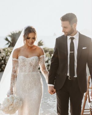 Cassie DiLaura Instagram - got my wedding photos back…incoming!!! 💍 
oh and it’s #valentinesday ❣️

HVD to my husband 🤭 aka my forever #valentine because you’re legally stuck with me now 😘 I love walking through life with you ILY 🥰

@photobyjulieta 
@thecapehotel 
@annettamcbain 
@dolceglow x @isabelalysa 
@blushnroses.cabo 
@cabocelebrations 
@alouisebridal 

#happyvalentinesday #newlyweds #wedding #bride #groom #husband #thecape #cabo #weddingphotos #weddingphotography #weddingvenue #mexico #cabosanlucas #dippedindolce #sleevesdress #lacedress #floraldress #weddingdress #weddingdressinspo #weddingdressinspiration #weddinginspiration #weddingdecor