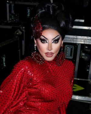 Cherry Valentine Instagram - Red-e for the stage! 🍒

Casual dance number for the @dragraceukbbc @vossevents tour ♥️ falling in love with the stage every night! 🔥

Look by @coquetryclothing stoned by myself… & @lawrencechaney (thx gurl) ✨
Hair by @mannhandledwigs 
📸 by @billyroysawyer