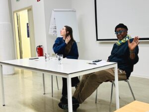Cheryl Dunye Instagram - This is how we did the holidays 🎁 Critical Barbra: Perspectives on the First Global Jewish Superstar at Gocthe University in Frankfurt (pictured is the presentation on Queer Jews by Michele Aaron, Warwick University), screened shorts in Paris with @piapia.asso.media, and screened “Black Is Blue” in Athens with the Lala artist residency. Sending you all love ❤️