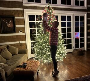 Chris Hardwick Instagram - It’s happening! Dimity’s first Christmas is officially at the beginning of its progress bar. @lydiahearst did a stellar job setting up the tree! Just a few more decorations and it’ll be in full Yuletide mode. Now you might think it’s a tad early, but normally we do a Halloween tree in Oct that rolls into Xmas so we’re actually right on schedule. 

If you zoom into the background, you can see that perfectly framed in a window pane is a reflection of @mariahcarey on the tv kickin’ off the season right.🎄

#xmas #ranchlife
