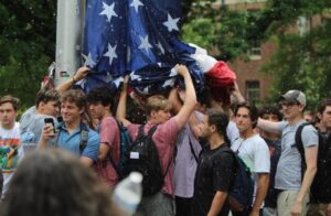 Dinesh D'Souza Instagram - Photo of the year:
Fraternity brothers are pelted by anti-Israel protesters at UNC Chapel Hill while protecting the United States flag as it is re-hoisted following its removal by protesters.