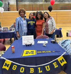 Dr. Meena Singh Instagram - It’s official! Anjali signed with Univ of Michigan! Busy week! Also presented her final senior capstone project and performed in her very last diversity assembly with selections from RRR ✊🏾
#goBlue #bollywooddancer