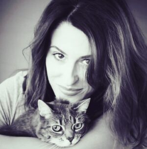 Elle Newlands Instagram - It’s the anniversary of Kayla’s passing from cancer. This was the last photo I got with her and I can see she was ready. I rescued her as a tiny sick kitten and no one wanted her because she only had one eye. Except when I got her home and gently washed her little face, I discovered she didn’t. It was just jammed closed with so much crust. She had a fever and was so dehydrated, the vet didn’t think she would live through the night. Little did they know, she had work to do and most of it was teaching me how to be a better and less selfish human. She lived 11 more years and she lived with such force that after she died in my arms, I felt all pieces of her leave. Her energy expanded one last time and then it just stopped being light. The room felt vacant and something shifted. 

Who knows where we go. I like to think that this isn’t it. That we all get a chance to reassemble somewhere in the great beyond. To level up in the spiritual realm. To report back what we learned and I hope it consists in it’s entirety of who we loved and who loved us. I hope it ends as it begins, with us learning to accept every lesson as a chance to grow and appreciate while we lived in these bodies on loan. I hope we empty our pockets of any residual longing in our hearts or painful regrets. The idea of unfinished business unsettles me. 

I know in my heart that Kayla finished what she came to do. She had aggressive lymphoma and the vet told me after she died that she had so many tumors, the fact she lived almost a year past diagnosis was quite frankly, a fucking miracle. But that was Kayla. A cat who didn’t know she was a cat. A cat who rescued this human and taught her to trust in unconditional love. She knew I needed her. This tiny, scrappy little rescue being, who let me know every single day she was alive, that she chose me back. And sometimes that’s enough because that’s the instruction manual for love and we’re just lucky when we get to build something to completion ❤️