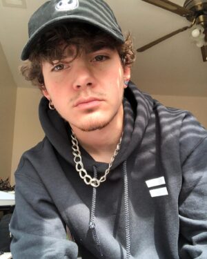 Elliot Fletcher Instagram - i look weird in these pictures but my @getrealmovement hoodie doesn’t!! thank you to them for sending me this hoodie and a matching tee! go grab something from them this pride month and remember to appreciate yourself!