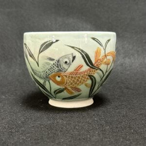 Emily Gravett Instagram - I really wasn’t sure how this would work. If the fish would be visible, whether the greens would shade down in the way I wanted, so I’m pretty delighted with how it turned out.  #ceramicsart #potterylove #porcelain #outofthekiln #teacupandsaucer
