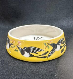 Emily Gravett Instagram - Here is the finished cat water bowl that I made for my sister @handmadeinSE20
I’m pretty pleased with how it turned out. I LOVE the yellow on the porcelain #outofthekiln #potterylove #ceramicsart #porcelain #magpie #fancycatbowl