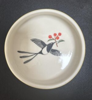 Emily Gravett Instagram - Here is the finished cat water bowl that I made for my sister @handmadeinSE20
I’m pretty pleased with how it turned out. I LOVE the yellow on the porcelain #outofthekiln #potterylove #ceramicsart #porcelain #magpie #fancycatbowl