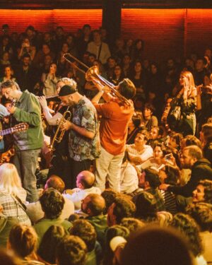 Erlend Øye Instagram - La Comitiva Spring Tour 2024, part 1. 
Milano, Torino, Padova, Bologna, Roma, Paris, Barcelona, Madrid, Lisboa. Moments on stage and  moments off-stage. 
In love with Europe and all of its urban and human  variety. What a treat to see it all in such a short period of time. How things change from place to place. 
We develop a lot how we play together, both within La Comitiva core members, and with Romain, Maaike and Kobi, the Win Winds. Stefano now brings a stomp-box that he operates with his foot, creating a sound similar to a bass drum. Romain plays pandeiro on some songs now and other percussions. 
We sold out the La Comitiva Album vinyl, but we are repressing and we should have it for Part 2 next week. Istanbul, Hamburg, London, Utrecht. Also me and Stefano will play and sign records at HHV record shop in Berlin on the 5th May. 
Thanks to everyone that came to these shows! Thanks for listening, dancing and taking active part in the shows. In a time where so many live-acts perform with backing tracks, i am proud we are going in the other direction, sometimes performing even without amplification.