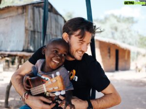 Evan Williams Instagram - This is Noel. We were buddies from day one. He followed me around the village most days, sticking to the trees, calm but shy. He would always point at my ukulele and say ‘guitara’. It was the only word I ever heard him say, when I spoke to him he would just smile wide and sparkle. There is nothing like the smile of a child. It takes up their whole face, their whole soul turns bright. When he reached out a tiny finger to pluck the strings for the first time he was entranced. I think we’ve got a little musician on our hands. 😊
Grateful to the people of Kadula, Malawi for welcoming us so warmly, and to the many supporters of our @buildOn primary school building project in the village. The school is now finished, and Noel and his friends have a springboard to support them in creating the lives they’re dreaming of. I can’t wait to see what’s next. ❤️