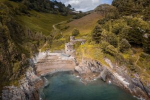Evelyn Edwards Instagram - This was the most random hike find EVER! We were actually looking for another castle altogether and then BAM! Hello cove with amazing little structure! ... Let me tell you it took me a while to find out what this place was called and what the heck it was. This isn’t technically a castle. It’s a sham castle. And before it was a sham castle it was a disused limekiln from the early 19th century that was made in to what you see in the later part of the century. It also houses an iron water wheel.  Sometimes getting a little lost can be pretty darn fun. .⁣
.
.
.
.
.
#devon #devonlife #devoncoast #castle #castlesofinstagram #castles #castlelove #historicalplacestovisit #history #historylovers #historylover #dronephotography #dronestagram #droneshots #droneoftheday #urbexuk ⁣
#oldbuilding  #historicplaces #historicalplaces #travelphotography #historicbuilding #historical #traveler #heritage #historicalplace #historichouse #oldhouse #architecturephotography  #historicarchitecture #medievalarchitecture