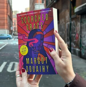 Gillian Flynn Instagram - We’re loving Sister Holiday’s new look….in paperback 🔥 SCORCHED GRACE by Margot Douaihy is out in paperback today from Gillian Flynn Books! 

Named a @nytimes Best Crime Novel of the Year, SCORCHED GRACE follows punk-rock nun turned amateur sleuth Sister Holiday as she solves the mystery of a shocking arson spree tearing her community apart.
 
And don’t miss the next mystery in the Sister Holiday series, BLESSED WATER, on sale March 12 💧🔍