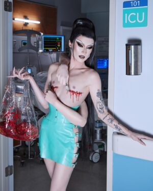 Gottmik Instagram - I don’t even know what to say about this look besides THANK YOU. This look is beyond just me. It is a piece of art and fashion that represents something that I never thought I’d be vulnerable enough to talk about let alone wear on the runway of @rupaulsdragrace This look represents the pain and suffering I went through while all at the some time experiencing complete trans queer liberation in a way that I hope everyone seeing this will feel one day. I found my peace within the fashion drag artistry space and I hope everyone finds theirs in one way or another. 🩸🔪 🏳️‍⚧️ 

Photos by @sanchezzalba 
Arms and bio hazard tit bag by @marcosquared @jon_neill 
Latex by @xvenusprototypex 
Hair by @jeanbaptiste.santens