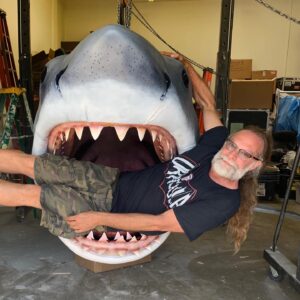 Greg Nicotero Instagram - Happy JAWS day released on this day in 1975!  While restoring the last original casting from the molds I couldn’t help but recreate this photo (minus the cutoffs). The shark now lives at the soon to be opened Academy Museum...and yes those teeth are sharp! #jaws