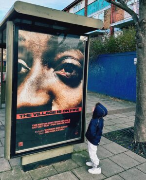 Guvna B Instagram - Dad used to send me shop on Freemasons 
Round the corner from Bridgeland
Opposite Custom House station 
Chip shop amazing
Corner shop adjacent 
Bosman said stay focused kids
You’re going places 
Fast forward it’s scary what’s been happening 
Too many RIP’s for the caption 
When we played out it was few and far between 
Now every other day a madness on the streets
Brothers can’t see so the mothers can’t sleep 
And we can’t rely on others to plant seeds 
It’s not a black problem as they have you believe 
It’s complicated and the roots run deep 
Change doesn’t happen overnight 
But till then we @powerthefightuk 
Cos when my son and his people grow up
They gotta know we showed love 
And that’s why we post up 

THE VILLAGE IS ON FIRE 🏚️