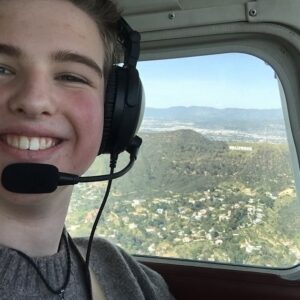 Iain Armitage Instagram - What a day!! On a recent, perfectly clear and gorgeous Los Angeles morning I joined Mr Larry and Ms. Amelia from @beactivepilot for my very first flying lesson! I had a fascinating lesson on the ground and then we took flight! We flew over Warner Brothers studio (where we film Young Sheldon) and over to Santa Monica. Here I am with the Hollywood sign in the background. It was incredible to get a different perspective on these landmarks I know so well. Thank you to everyone there for giving me one of the very best days of my life! I can’t believe I flew a plane!!! I will be getting my drivers license soon- maybe I also need a pilots license??!