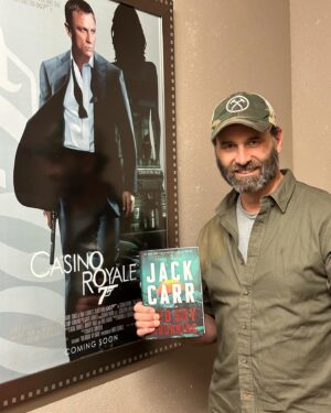 Jack Carr Instagram - Walked into the back room at @murderbooks tonight to be greeted by this CASINO ROYALE movie poster.  I’m taking this as a good sign for my 007th book! 

#JackCarr #JackCarrUSA #RedSkyMourning #JamesReece #JamesBond #CasinoRoyale #BookTour