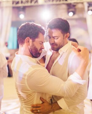 Jaymes Vaughan Instagram - Two years ago today I got to marry my best friend. For as long as I can remember I used to dream about marrying my husband, and what it would feel like to find my forever person. Two years in I can honestly say it is way better than anything I ever dreamed of. I get to wake up every day with my best friend, my practical jokester, my soul mate. 
If I could be Dad for a second and offer just one thing I’ve learned about love, it’s this:
Don’t settle. Be open to love, but don’t settle. Wait until you find that person that it’s so obvious it practically hits you over the head. That person that it is so easy to just exist beside. That person that makes you feel like you can exhale. That person that makes you feel safe to be every part of yourself. That person that you’re excited to see even if you’ve just seen them 5 minutes ago. That person that feels like you’ve known them your whole life, when they show up…lock them down. That’s the one. 
Growing up gay, so many hateful things got put into my head that really messed up what I thought love was, I thought love was supposed to hurt me…so I let it. Then, my person came along and slowly and carefully fixed all that…he showed me what love is actually supposed to be. It’s uplifting, it’s safe, it’s consistent…it never hurts you, in fact, it heals you. 
I love you @jonathandbennett, Happy Anniversary my Prince. Thank you for being my one. Forever.

📷 @toddthephotographer