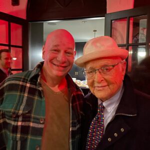 Jeff Ross Instagram - Norman Lear was 101 years old and still partying !

After Jada’s infamous Oscars incident I wrote a magazine editorial about my personal experience with alopecia. Norman called me, told me he enjoyed the article, and offered me his hat. 

Once when I told Norman that Gilbert Gottfried was sick he said “Laughing adds time to your life and Gilbert gave me years”. 

Long live King Lear. He added years to our lives. 

Sending love to his friend @carmensandiegola and his family.