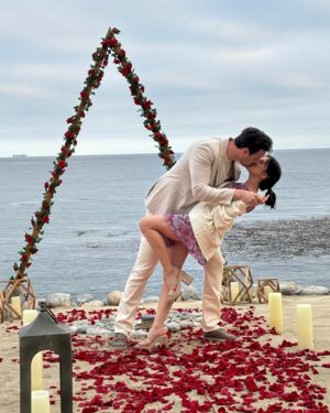 Jim Lee Instagram - Last weekend, we celebrated our daughter @brittanym.jpg’s engagement to her boyfriend @s4rge_ by hiding behind some tabletops at the @terranearesort cliffs overlooking the Pacific and witnessed Brandon pulling off a master class on how to create the most romantic surprise—an amazingly sweet, thoughtful and beautiful proposal. Afterwards, we jumped out from our hiding spots, all teary eyed, and gave big hugs to the newly engaged couple, followed by an incredible meal with all the immediate friends and family who had assembled for this unique and special moment!  Over 8 billion people on this blue planet and these two—Brittany and Brandon have found their special someone in each other, and in the process, changed each other’s lives for the better.  To paraphrase Huey Lewis and the News— power of love is not to be trifled with. 😍Wishing these two lovebirds a joyous and love filled engagement as they plan their upcoming big day and the start of their beautiful life together as one. ❤️❤️❤️