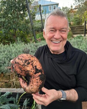 Jimmy Barnes Instagram - First rain free day so it’s me with a pitchfork digging up sweet potatoes. Looks like we’ve got them just in time, some of them are enormous. We’ve got to leave them resting for a few weeks for the sweetness to come in. Who remembers ‘Greenacres’ on TV? That’s me and @jane13barnes . Except Jane can cook a bit, she’s made us a raspberry rocky road frozen yoghurt ice cream.