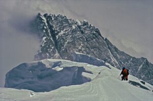 Jon Krakauer Instagram - On this day 26 years ago I shot this photo of the Australian climbing guide Mike Groom on the southeast ridge of Everest at sunrise. I shot the 2nd photo from the summit 8 hours later as cumulonimbus clouds were boiling up from the valley below. A violent storm soon engulfed the mountain, killing 8 people—including my kind, courageous, absolutely wonderful friends Doug Hansen and Andy Harris, seen in the 3rd photo posing with me during the basecamp puja 25 days before the disaster. I still grieve deeply for them. Hit the link in my profile to read more about that terrible day.